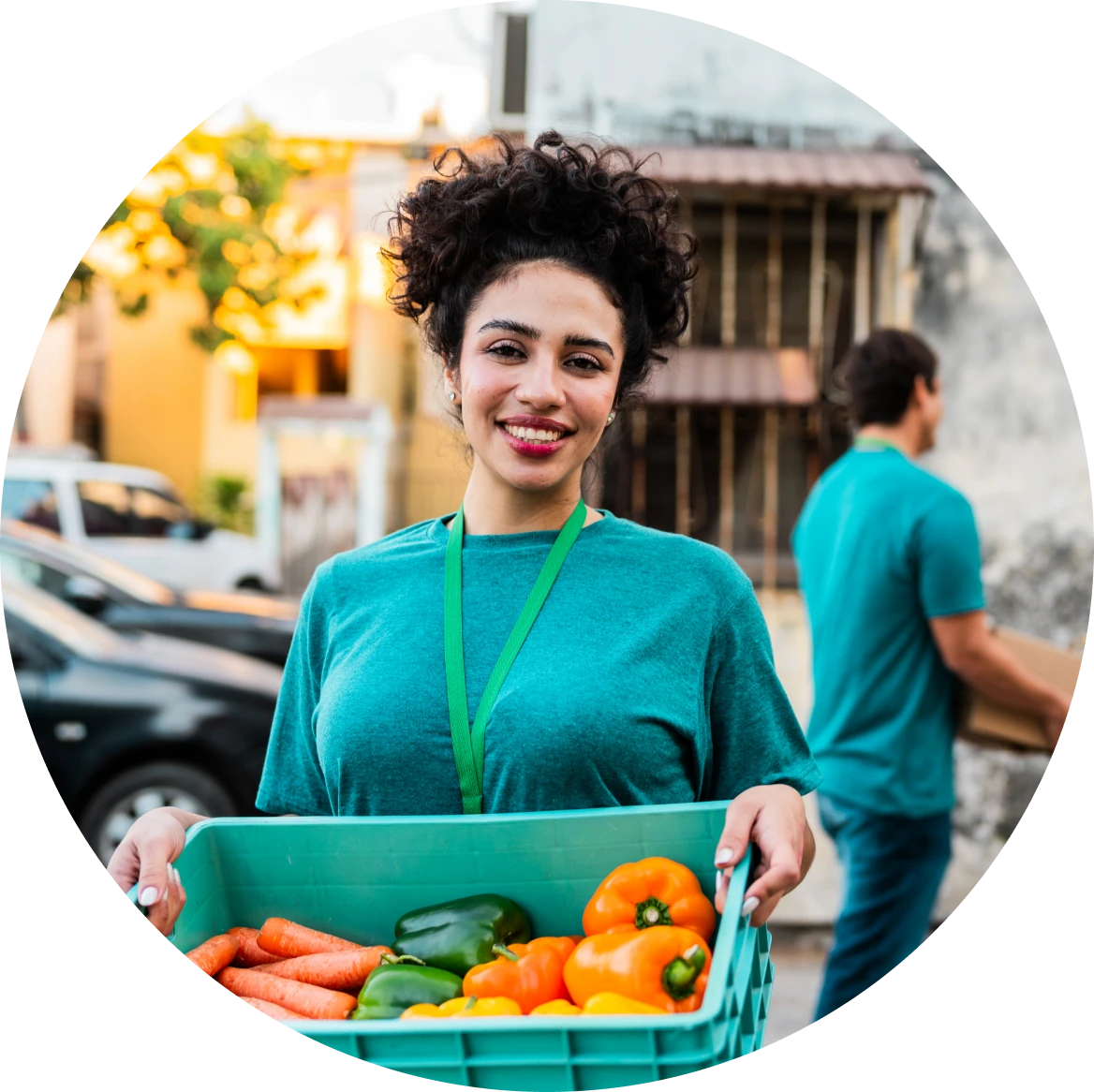 Woman holding crate of fresh vegetables