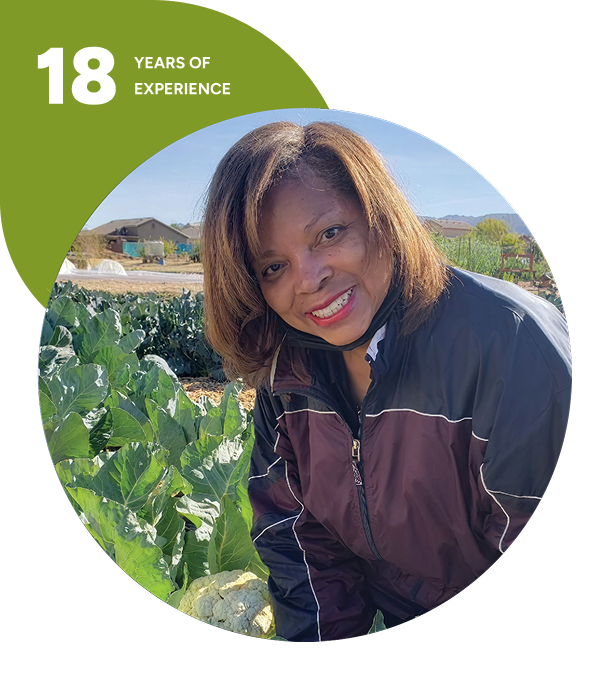 Smiling woman in cabbage field