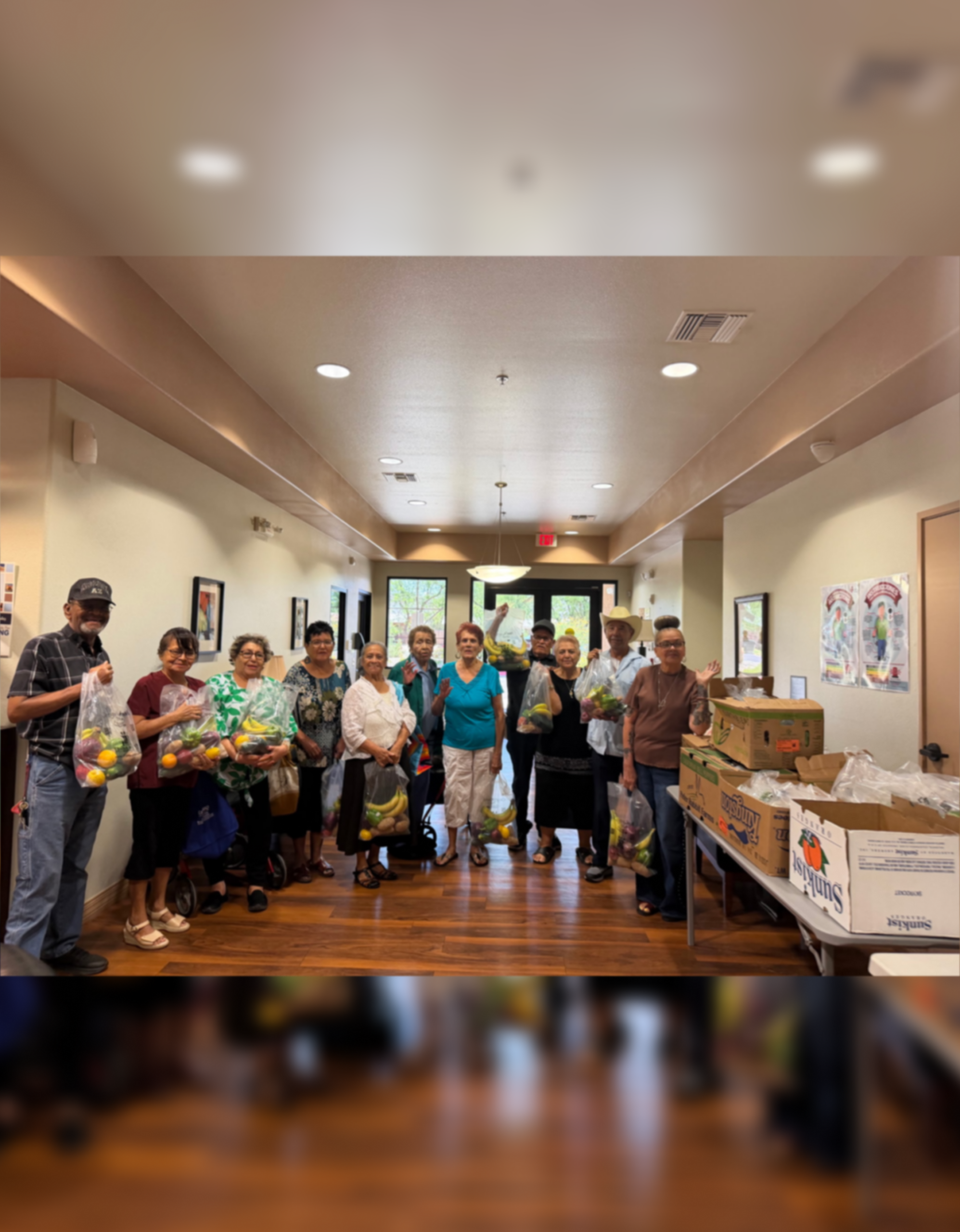 People holding groceries at community food distribution
